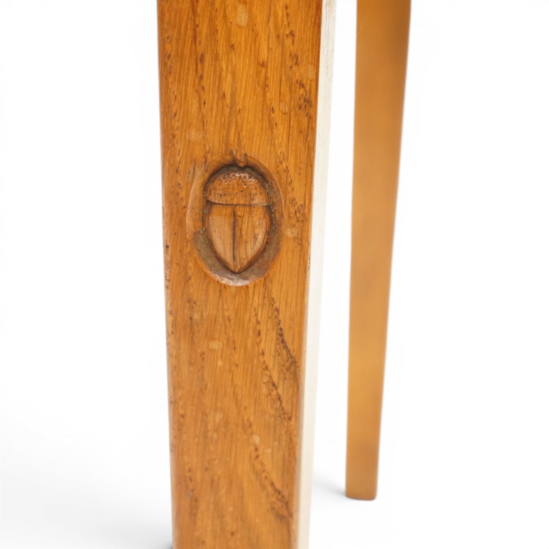Acornman - set of four oak dining chairs, chamfered slatted back, tan leather drop in seat, raised on square supports with carved acorn signature, by the workshop of Alan Grainger of Brandsby