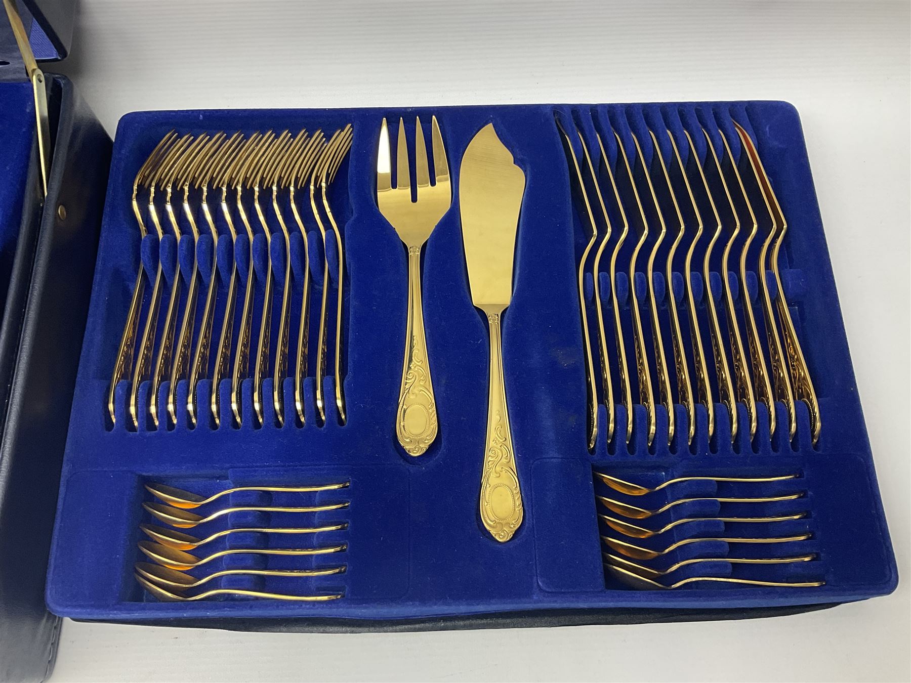 Bestecke Solingen canteen of gold plated cutlery for twelve place settings, including ladle, cake slice, fish servers, fish knives and forks, 108 pieces total, contained within a briefcase 