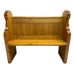 20th century waxed pine hall bench or pew, plank back over solid seat, flanked by shaped end supports