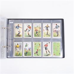 Collection of Edwardian and later Football related trading and cigarette cards, including forty-nine of fifty 1906 Ogden's Football Club Colours, 1922 PALS Footall series, ninety of one hundred 1925 Gallaher Famous Footballers, complete set of forty-four 1926 Ogden's Captains of Association Football Clubs and Colours, complete set of fifty 1927 Players Football Caricatures by MAC,  complete set of fifty 1927 Players Football Caricatures by RIP,  complete set of fifty 1930 Players Association Cup Winners, complete set of 50 1933 Ogdens AFC Nicknames etc, housed in brown cigarette card album