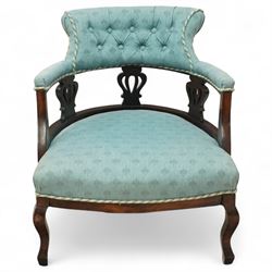 Late Victorian mahogany upholstered tub chair, curved button-back with rope-edge trim over open shaped arms and pierced splat supports, rounded seat upholstered in patterned blue fabric, raised on cabriole front supports