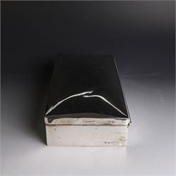 Two silver cigarette boxes, comprising early 20th century plain rectangular example with compartmentalised softwood interior, hallmarked Birmingham 1914, maker's mark indistinct, and an early 20th century example with engine turned decoration and engraved initials to cover, hallmarks worn and indistinct, largest H4.5cm, W21cm