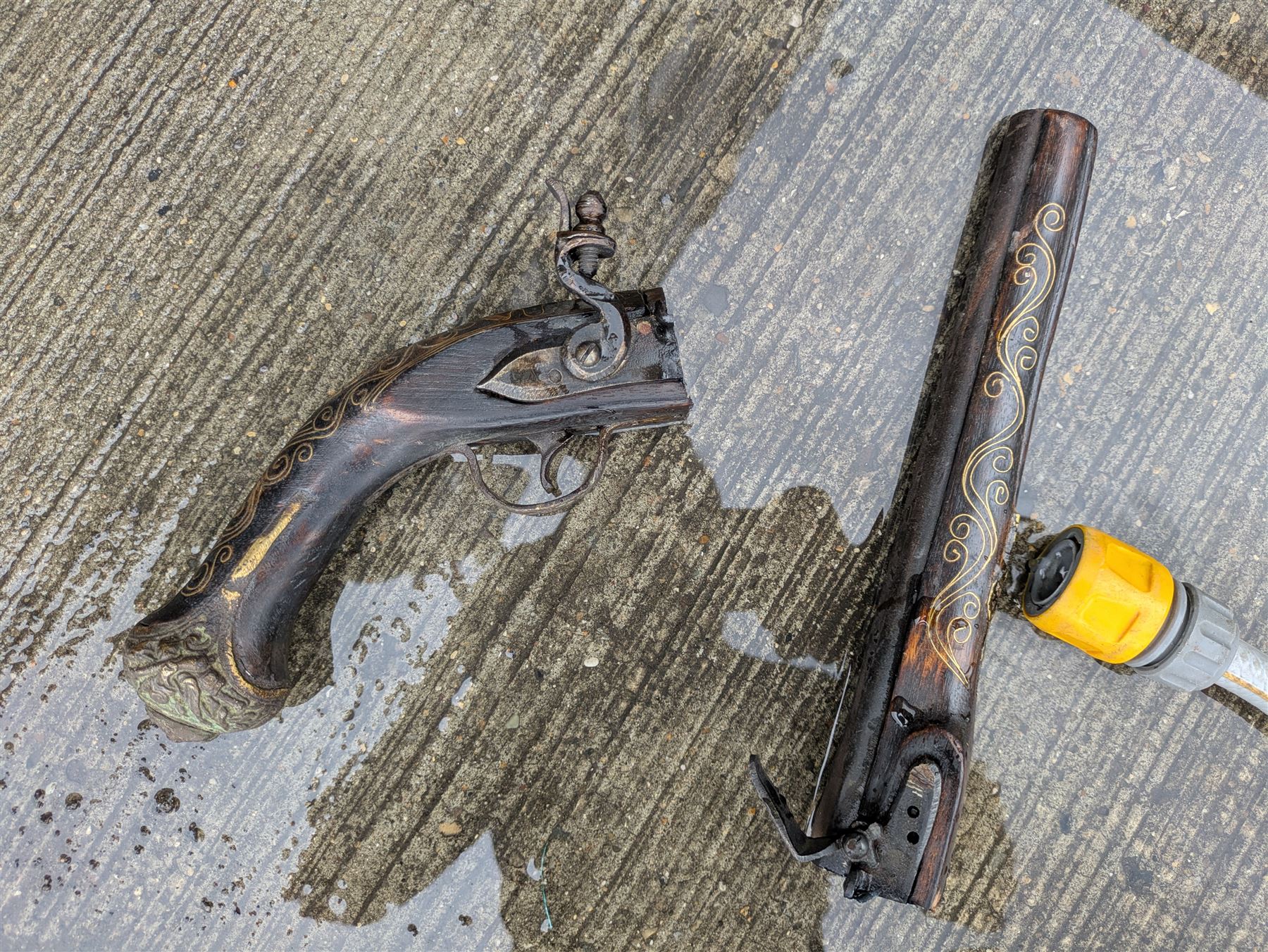 REGISTERED FIREARMS DEALERS ONLY - Reproduction flintlock pistol, the full walnut stock with brass filigree inlay and mounts and skull crusher butt L46cm; no visible proof marks - Disposed 25.06.25 - Notified 24.07.25