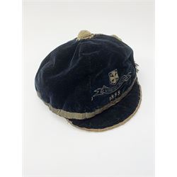 A Victorian rugby cap for Cumberland, the black velvet cap with gold coloured thread and tassel, dated 1888. 