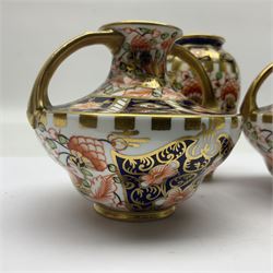 Pair of Royal Crown Derby 6299 imari miniature two-handled vases, together with another miniature vase of baluster form, all with printed mark beneath, tallest H8cm 