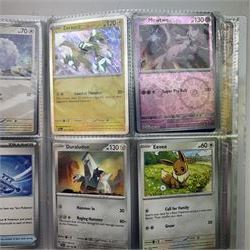 Collection of modern Pokemon TCG trading cards from the Scarlet & Violet and Sword & Shield eras, contained within in two folders, opened packets and loose, together with a graded Sword & Shield Silver Tempest Passiman TG08, GET Graded 9 Mint, two oversized cards, energy cards, vintage booklets and boxes, empty tins, 1998 Electronic Pokédex and other accessories