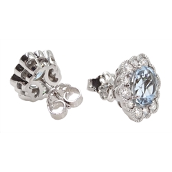 Pair of 18ct white gold oval aquamarine and diamond cluster stud earrings, hallmarked, total aquamarine weight approx 2.50 carat, total diamond weight approx 0.75 carat