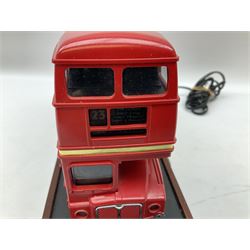 Novelty telephone in the form of a London Routemaster bus, c1997, fitted on wooden plinth with modern connection L25.5cm