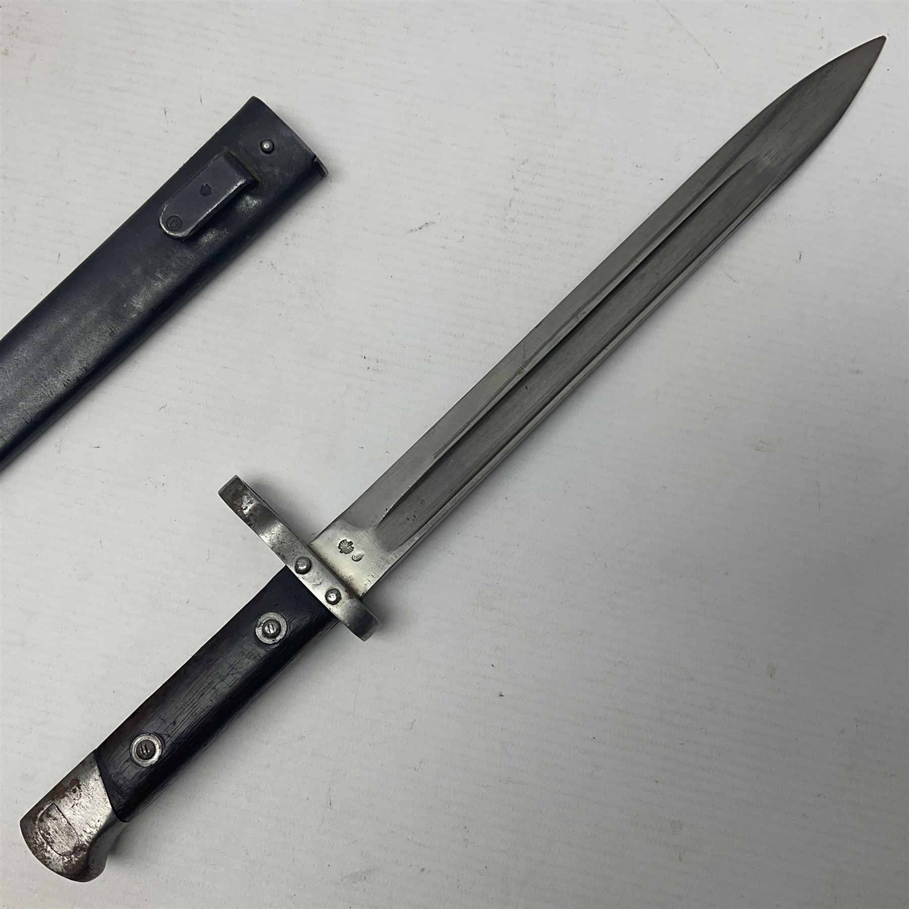Austrian Model 1895 Carbine knife bayonet with 24.5cm fullered steel blade; various marks to the ricasso including F.G. GY.; cross-piece marked No.7843; in steel scabbard L37cm overall