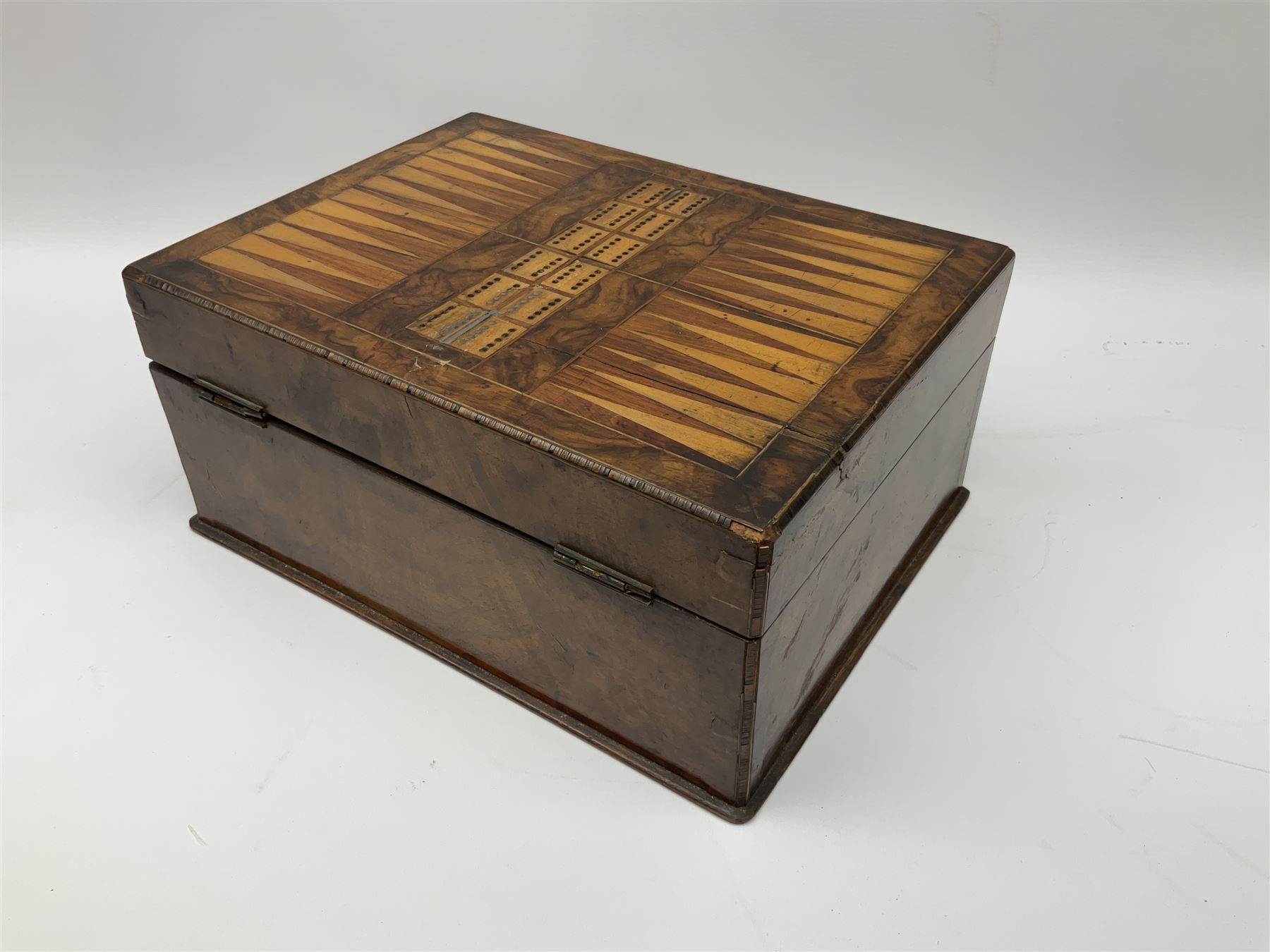 Victorian walnut sewing box, the hinged lid decorated with inlaid backgammon and cribbage board lifting to reveal lined compartmented interior with lift out tray