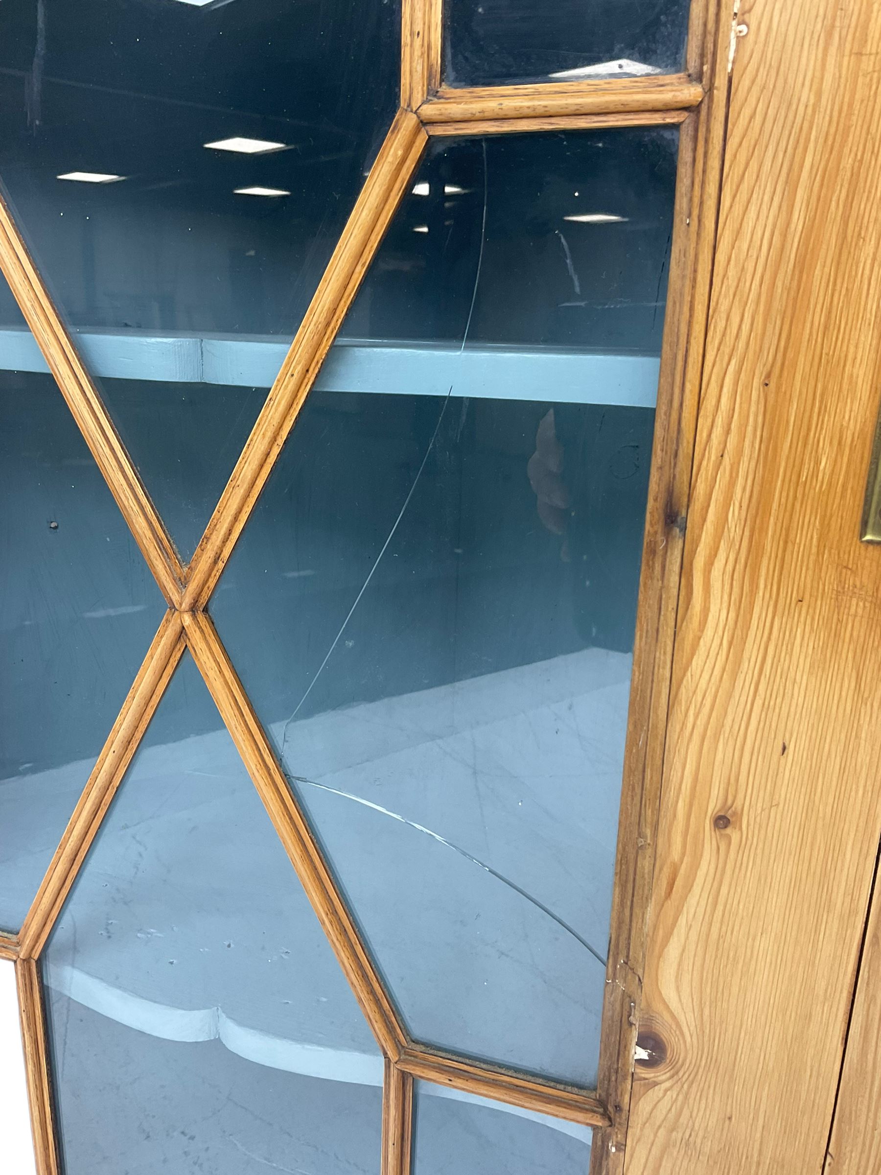 Early 19th century pine corner cabinet, projecting dentil cornice over astragal glazed door