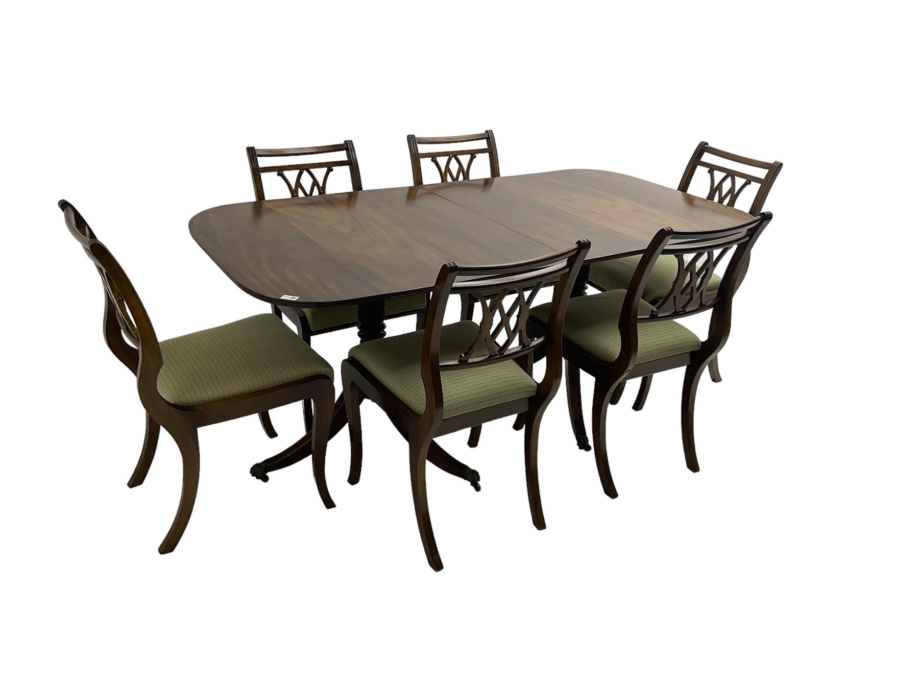 Regency design mahogany twin pedestal dining table, rectangular top with reeded edge, acanthus carved turned column terminating in reeded tripod base with hairy paw feet and castors (W172cm D92cm H75cm) and set eight (6+2) Regency design mahogany dining chairs, pierced back with scroll design, seat upholstered in patterned laurel green fabric, raised on reeded sabre supports (W48cm H88cm)