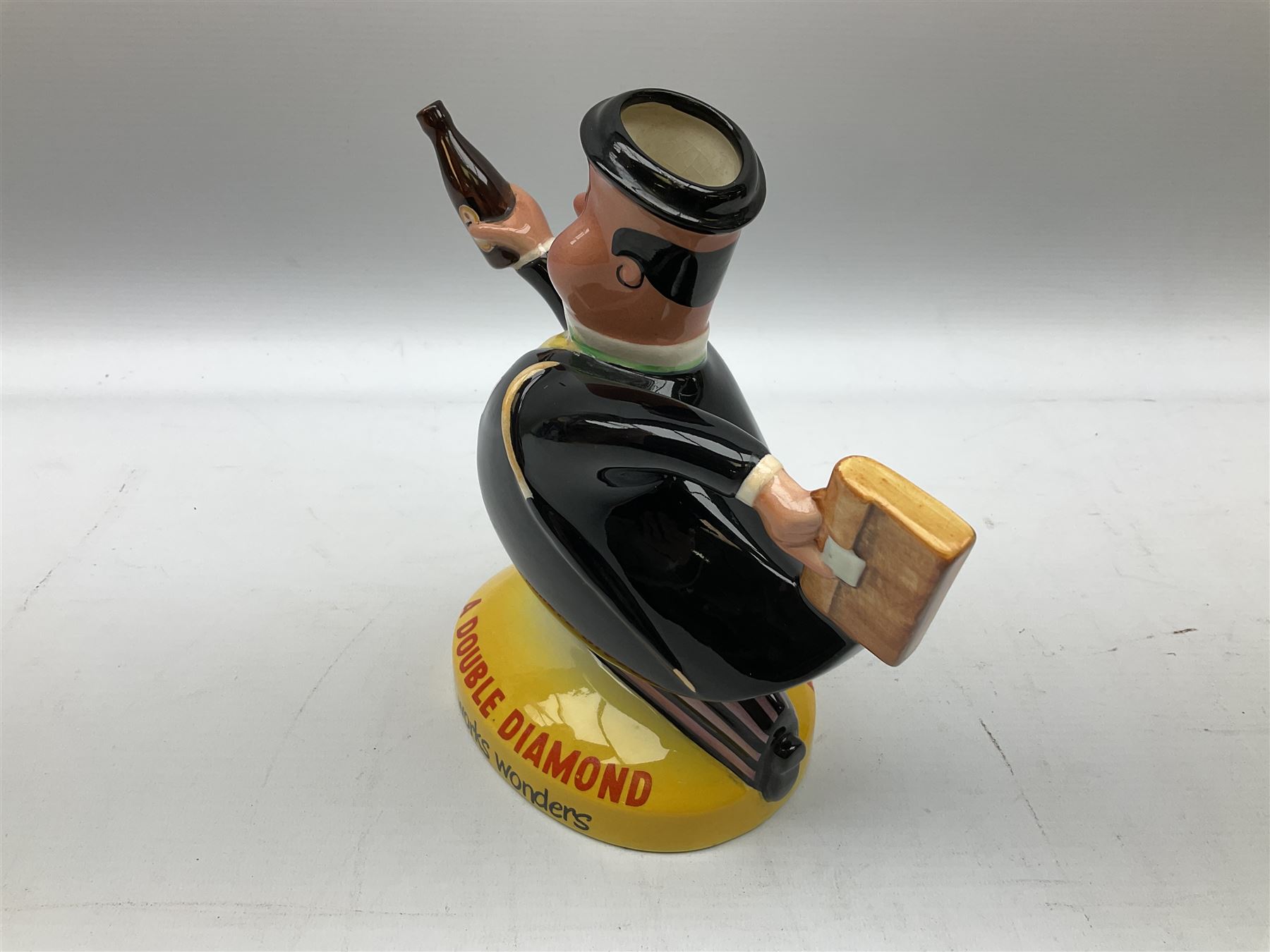 Beswick 'Double Diamond Works Wonders' advertising decanter in the form of a business man with briefcase and bottle, with impressed and printed marks beneath