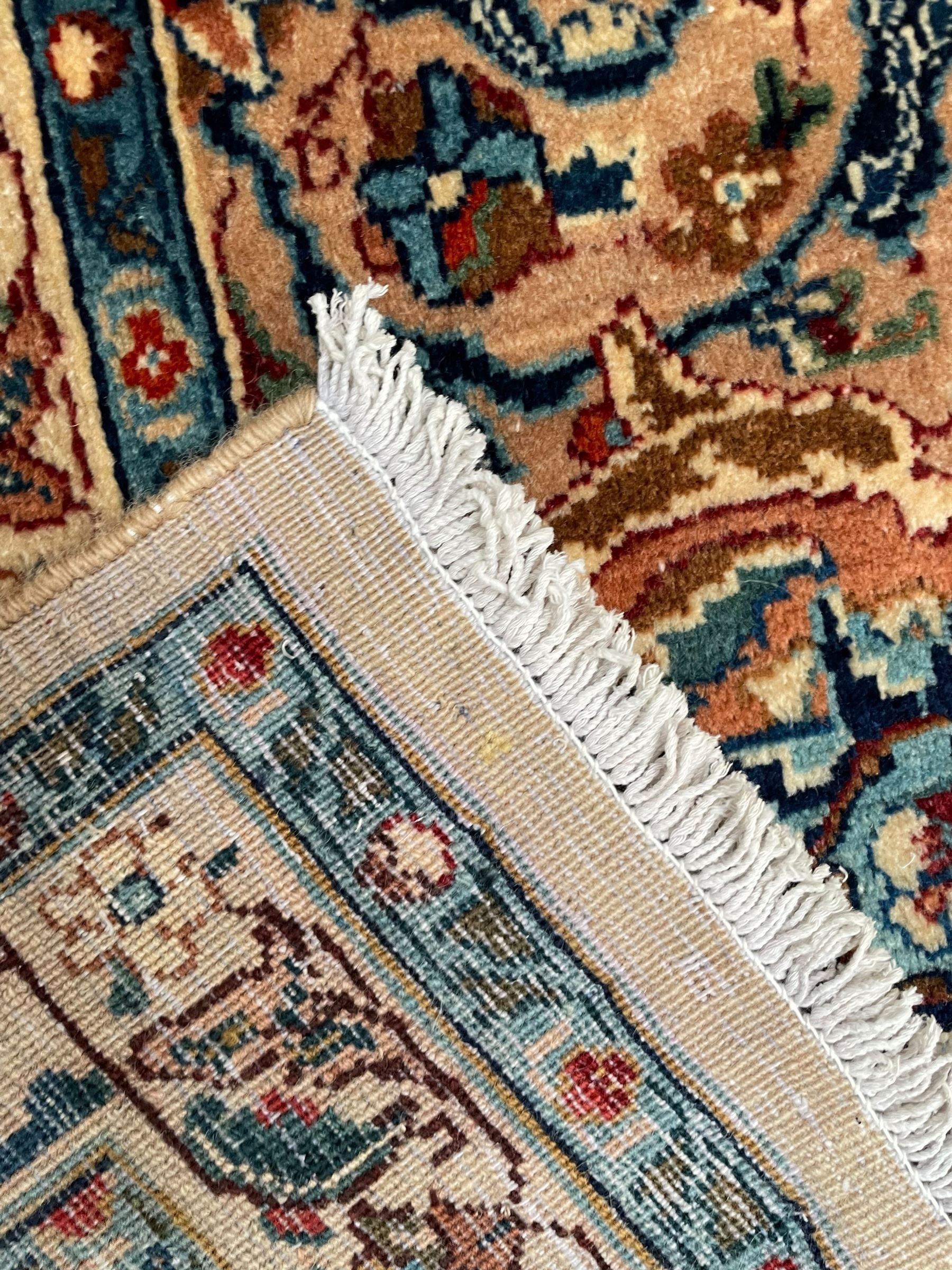 Persian Kashmar camel ground carpet, palmette rosette medallion on a field of curling leafy branches and stylised plant motifs, scrolling border decorated with further palmettes, within floral pattern guard stripes