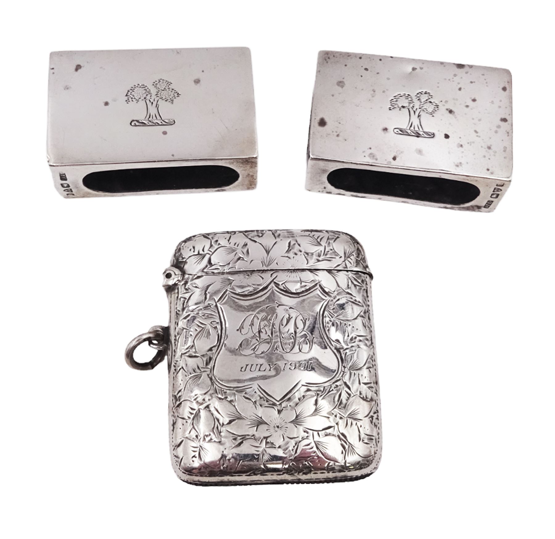 Pair of early 20th century silver matchbox covers, each of typical form, engraved with a tree to the centre, with personal engraving to reverse, hallmarked Stokes & Ireland Ltd, Chester, date letter worn and indistinct, together with a late Victorian silver vesta case, engraved with floral decoration, with monogrammed shield shaped cartouche to centre, hallmarked E V Pledge & Son, Birmingham 1900