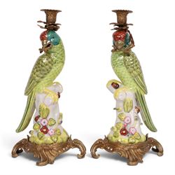 Pair of candlesticks, modelled as green parrot upon a flowering branch, upon four gilt aca...