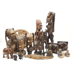 A group of African carved hardwood busts, together with further carvings, together with a bronze African figural bell, and a figure of an elder holding a staff, etc. 