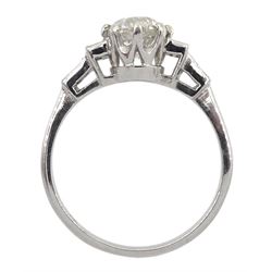 Platinum round brilliant cut diamond ring, with baguette cut stepped diamond shoulders, stamped, central diamond approx 1.05 carat, total diamond weight approx 0.30 carat