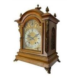 German - 19th century 8-day walnut bracket clock, striking the quarters on two coiled gongs, case with a break-arch top surmounted by cast brass finials, canted corners to the front with cast brass caryatids and sound frets to the sides, brass break arch dial with a silvered chapter ring, steel gothic hands, spandrels, and pendulum regulation dial. With pendulum.