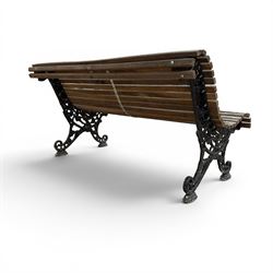 19th century cast iron and wood slatted garden bench, serpentine scroll form, ornate bow ends finished in green paint