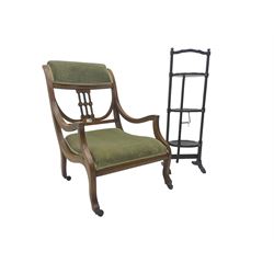 Edwardian inlaid walnut framed low elbow chair, pierced and inlaid back, cresting rail and seat upholstered in sage green velvet, on ceramic castors (W54cm H78cm); and early 20th century mahogany three tier cake-stand (H89cm)