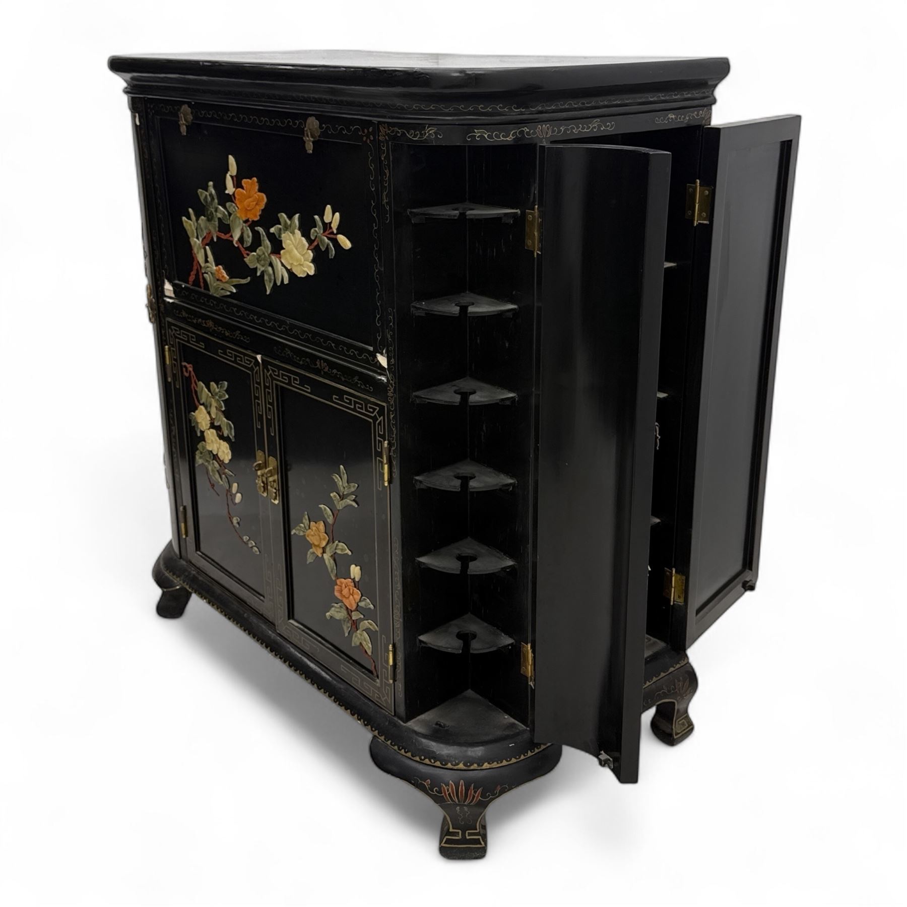 Early 20th century Chinoiserie lacquered cabinet, rounded rectangular top above a fall front enclosing fitted interior with lacquered decoration, over a pair of cupboard doors and flanked by side compartments with tiered bottle shelves, the black lacquer ground decorated throughout with raised and painted floral sprays, on shaped bracket feet
