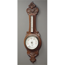  Early 20th century carved oak cased aneroid barometer with thermometer, H91cm  