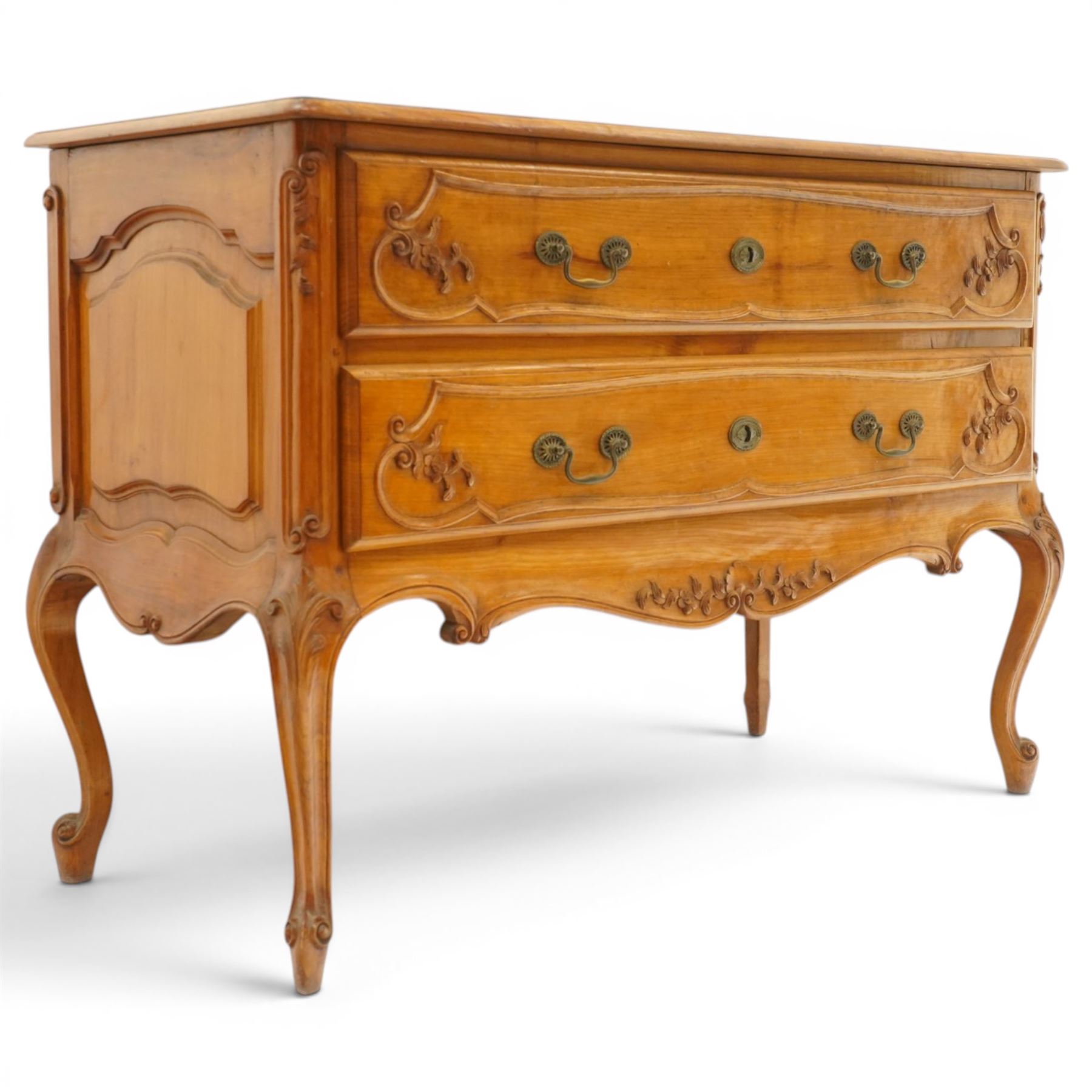 Early 20th century French fruitwood commode chest, rectangular top with moulded edge, fitted with two long drawers with moulded scroll and floral decoration, shaped apron with moulded scallop motif and trailing foliate, raised on cabriole legs with acanthus carved knees and scroll feet