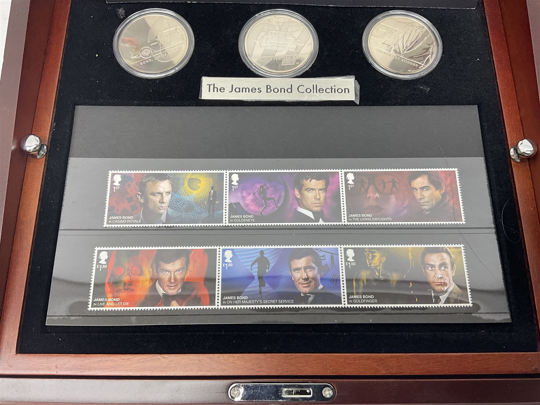Danbury Mint 'The Ultimate James Bond Collection' comprising stamps and coins housed in a display case, 'Concorde Queen of the Skies' sculpture, stamps, medallion display and 2020 'Centenary of the Unknown Warrior' five pound coin cover in Harrington and Byrne folder