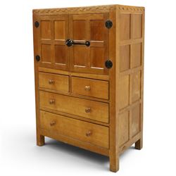 Mouseman - mid-20th century adzed and panelled oak tallboy chest, arcade carved cresting rail over two panelled cupboard doors with wrought iron fittings and latch, enclosing single shelf, over two short and two long drawers with lightly adzed facias and turned knob handles, raised on square supports, relief carved mouse signature, by the workshop of Robert Thompson of Kilburn
