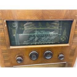 1950 Bush Type PB22 valve radio with Bakelite knobs and central glass tapering panel between with gilt metal mesh speakers, W58cm H42cm D24cm, together with Cossor floor standing radio in walnut veneer case and a Globetrotter radio of Art Deco style with Bakelite knobs and mirrored central panel, H50cm (3)