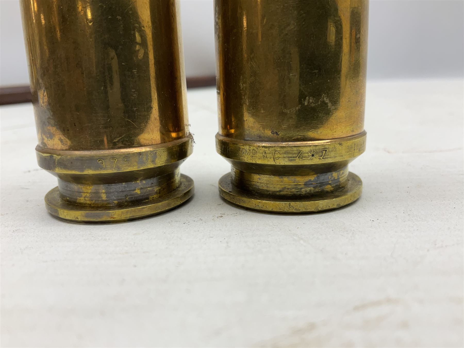 WW2 copper and brass bugle inscribed George Potter & Co, Aldershot 1939 L28cm; two cane and one leather covered swagger sticks; and three small pairs of plain brass shell cases (10)
