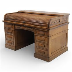 Globe Wernicke - Oak roll top desk, fitted with nine drawers, oak tambour roll top revealing a fitted interior, with single frieze drawer, flanked by four drawers to each pedestal, on a plinth base