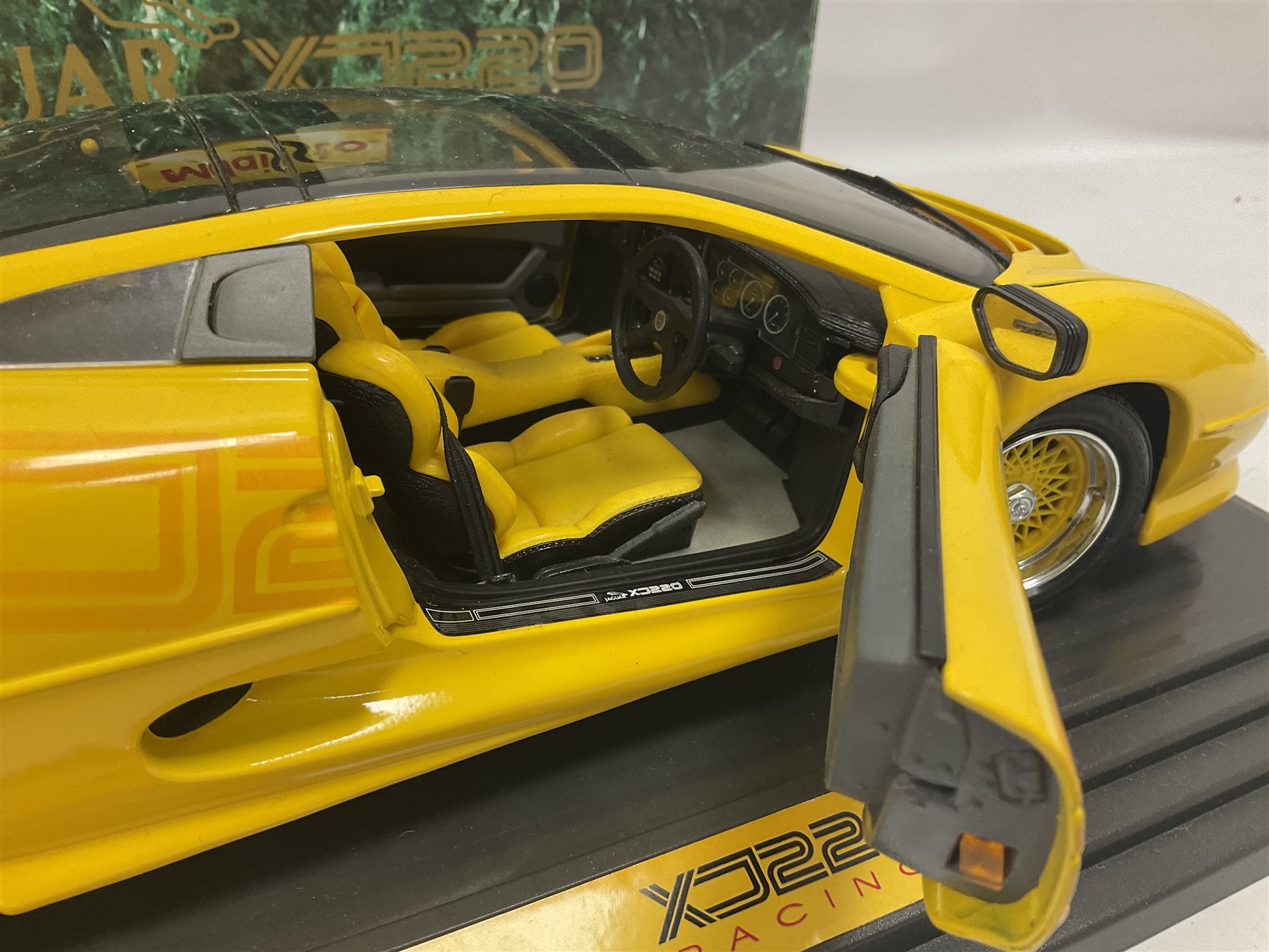 Two Maisto 1:12 scale Jaguar XJ220 ‘Racing’ cars in yellow, both on plinths in original boxes 