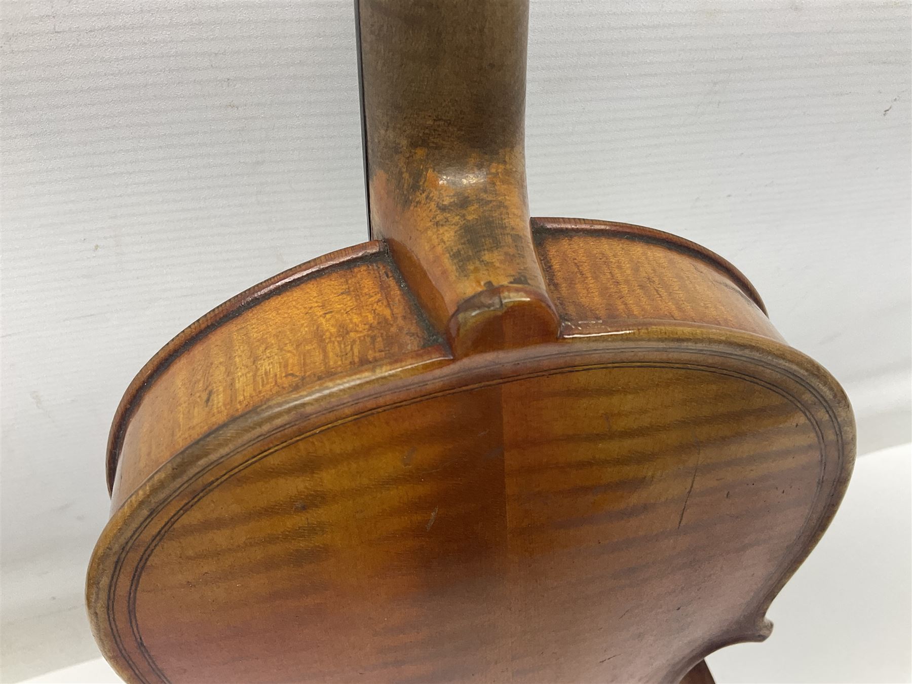German trade violin c1900 copy of a Maggini with 36.5cm two-piece maple back and ribs and spruce top; double scroll; L60cm overall; in carrying case