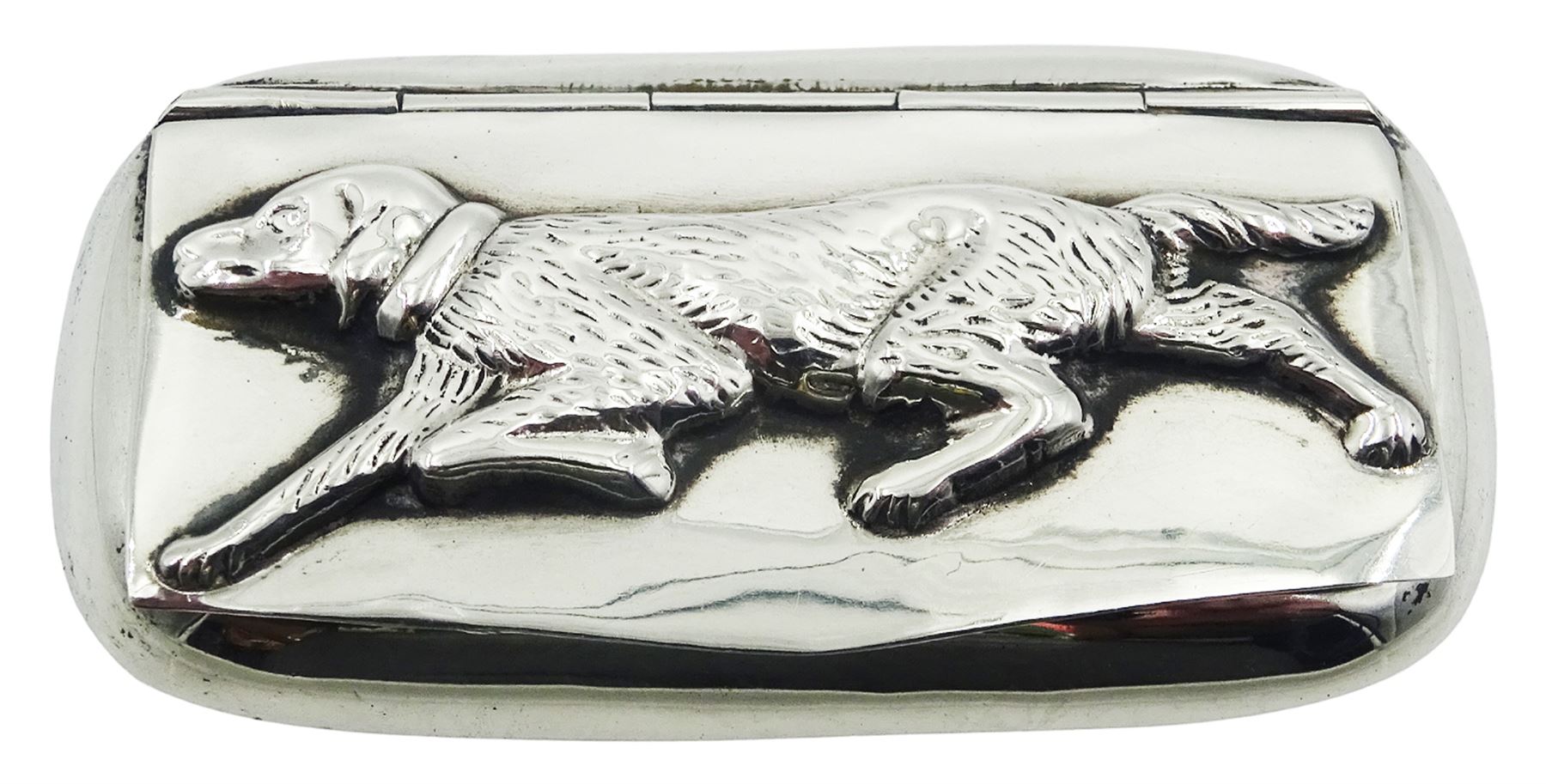 Modern silver snuff box, of rounded rectangular form, the hinged cover decorated in relief with a dog, hallmarked C M E Jewellery Ltd, Birmingham import 1994, and stamped 925, approximate weight 0.80 ozt (25 grams)