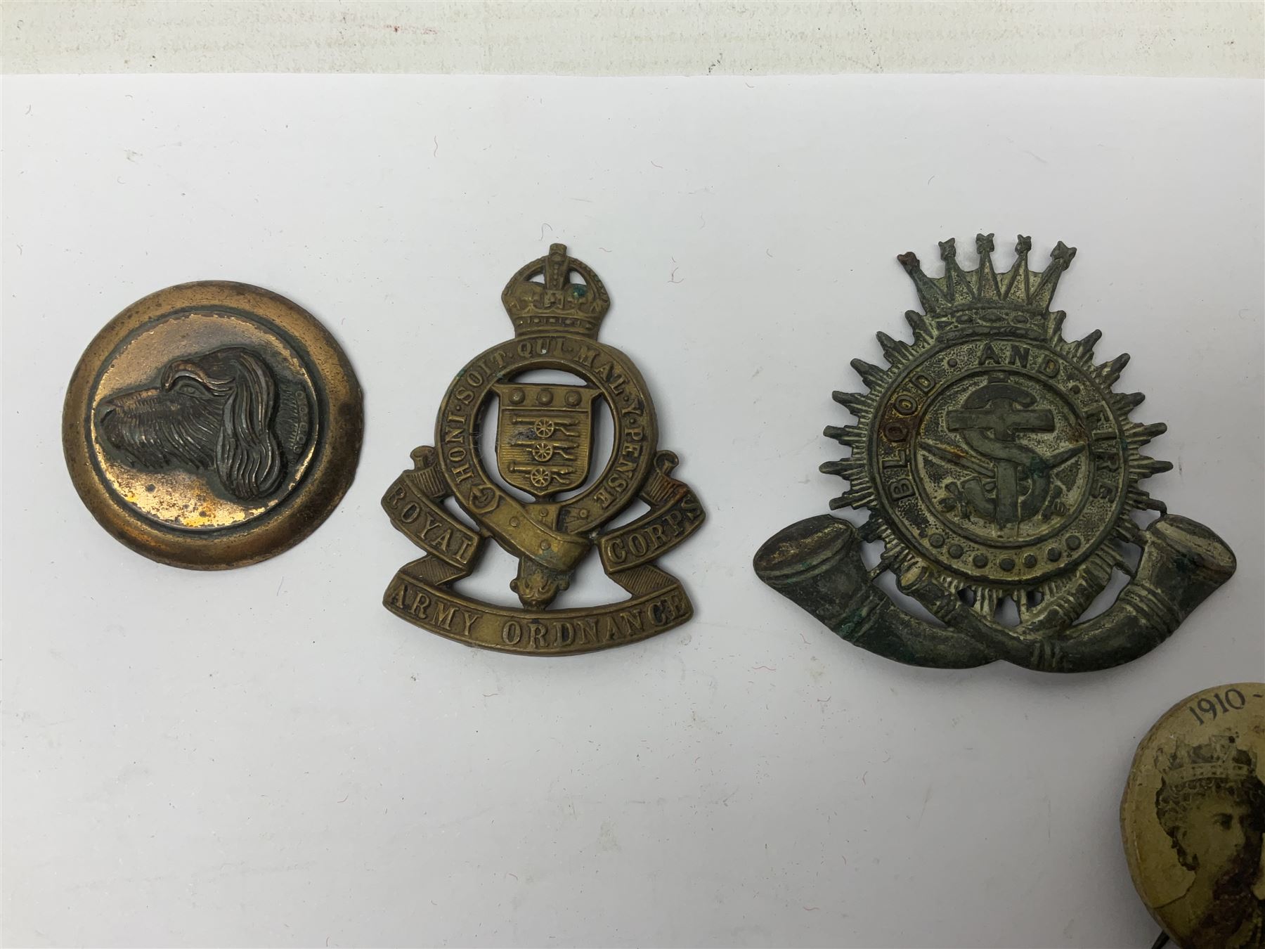 Made-up group of three WWI medals comprising 1914 Star awarded to 23598 Gnr. F. Jefferson R.G.A., British War Medal and Victory Medal with names removed; with ribbons on wearing bar; 1942 Motorist's Medal and small quantity of cap badges, Royalty badges etc