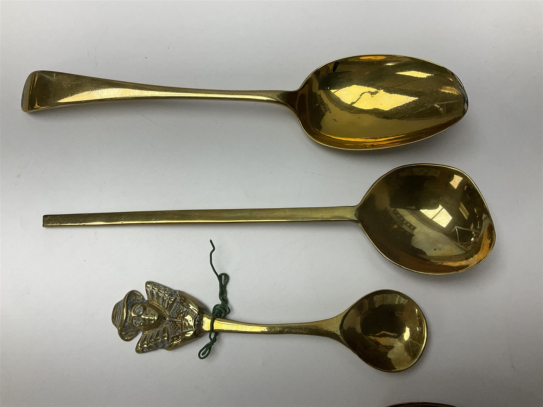 George III oak spoon rack and candle box, the rectangular backplate with shaped  pediment and two six aperture spoon racks, above a candlebox with hinged cover, with various brass spoons and a pair of brass candle snuffers, H56.5cm, W35cm, D14cm 