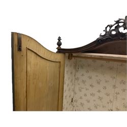 Early 20th century Italian walnut armoire wardrobe, the pierced and scrolling pediment carved with acanthus leaf detail, flanked by two scrolling cartouche with matching corbels below, the two panelled doors with applied carved rinceaux slips, with a central spiral turned upright, enclosing single shelf and hanging rail, raised on scroll feet