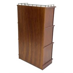 Mid-20th century mahogany open bookshelf, the rectangular top with a brass balustrade gallery, over three shelves each supported by turned column uprights, on shaped apron base