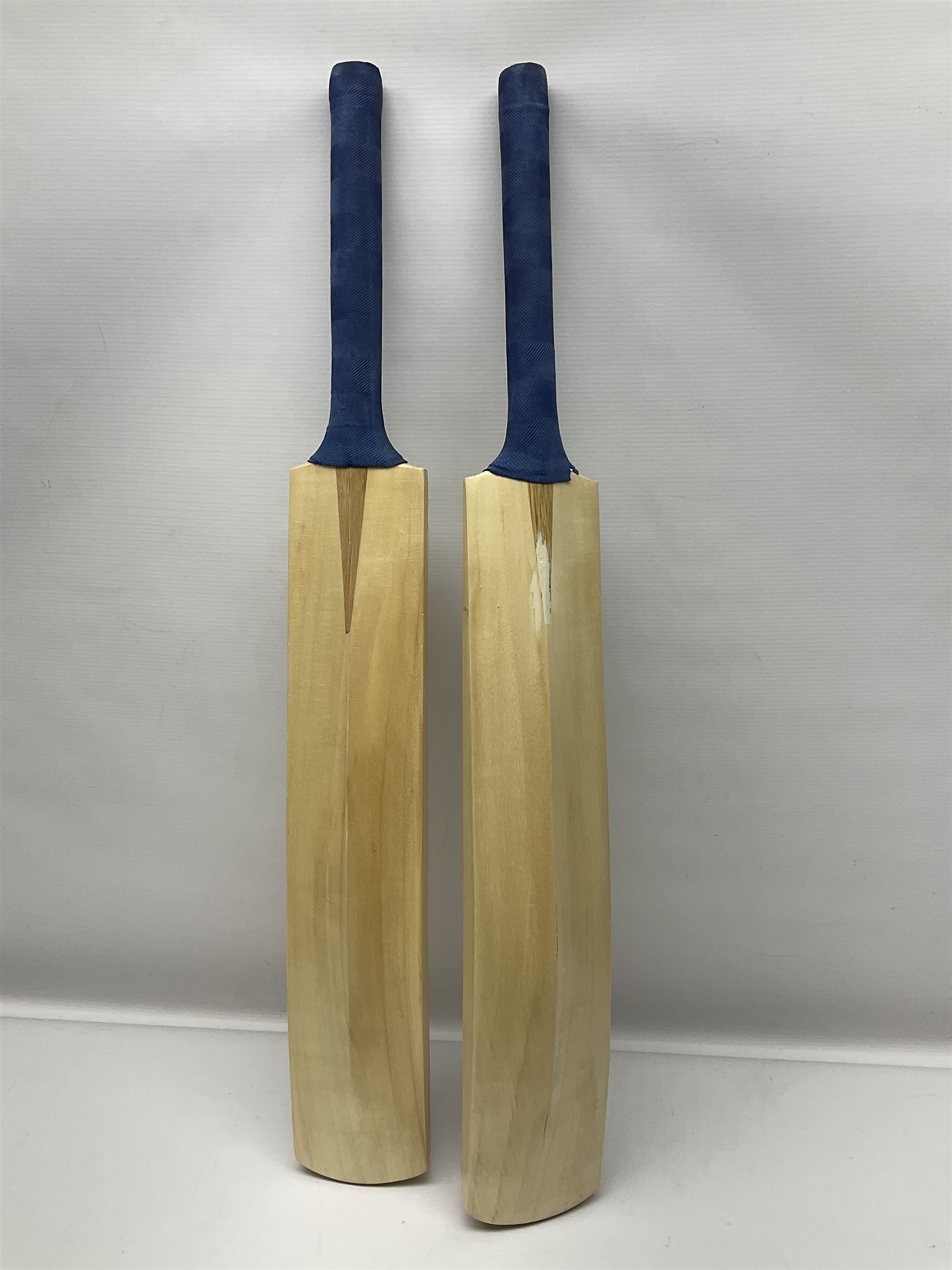 Two signed Yorkshire County cricket bats, from 2013 and 2014 seasons, bearing signatures including Johnny Bairstow, Joe Root, Tim Bresnan, Andrew Gale, etc