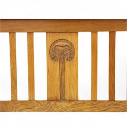 Art Nouveau oak double bed headboard, rectangular form with vertical slats centred by a carved stylised floral roundel
