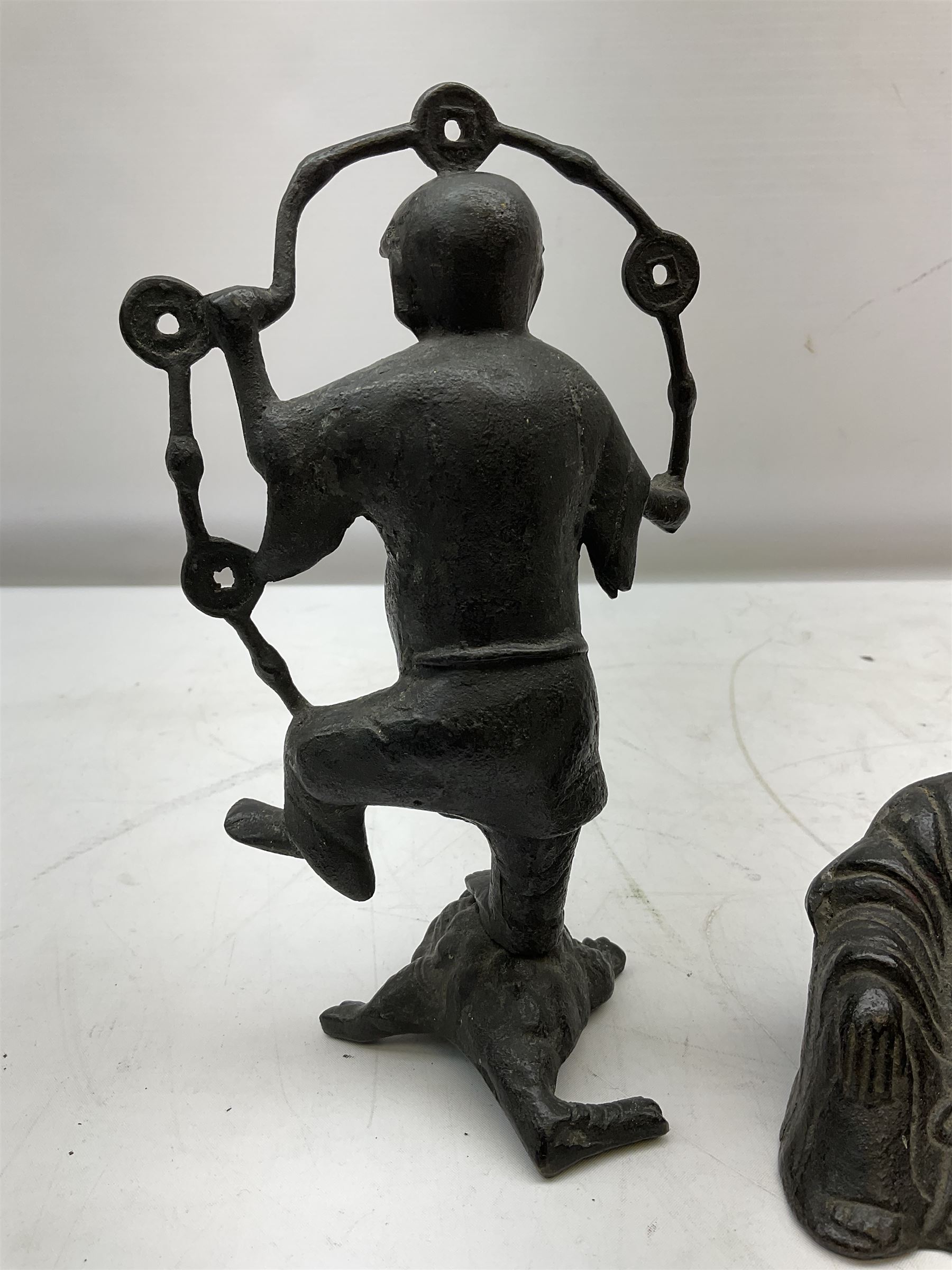 Cast iron figure of Liu Hai, the Chinese God of Wealth modelled standing with one foot upon mythical three-legged chánchú toad and holding a string of Chinese coins, H21cm, together with a cast iron figure of a seated laughing Buddha