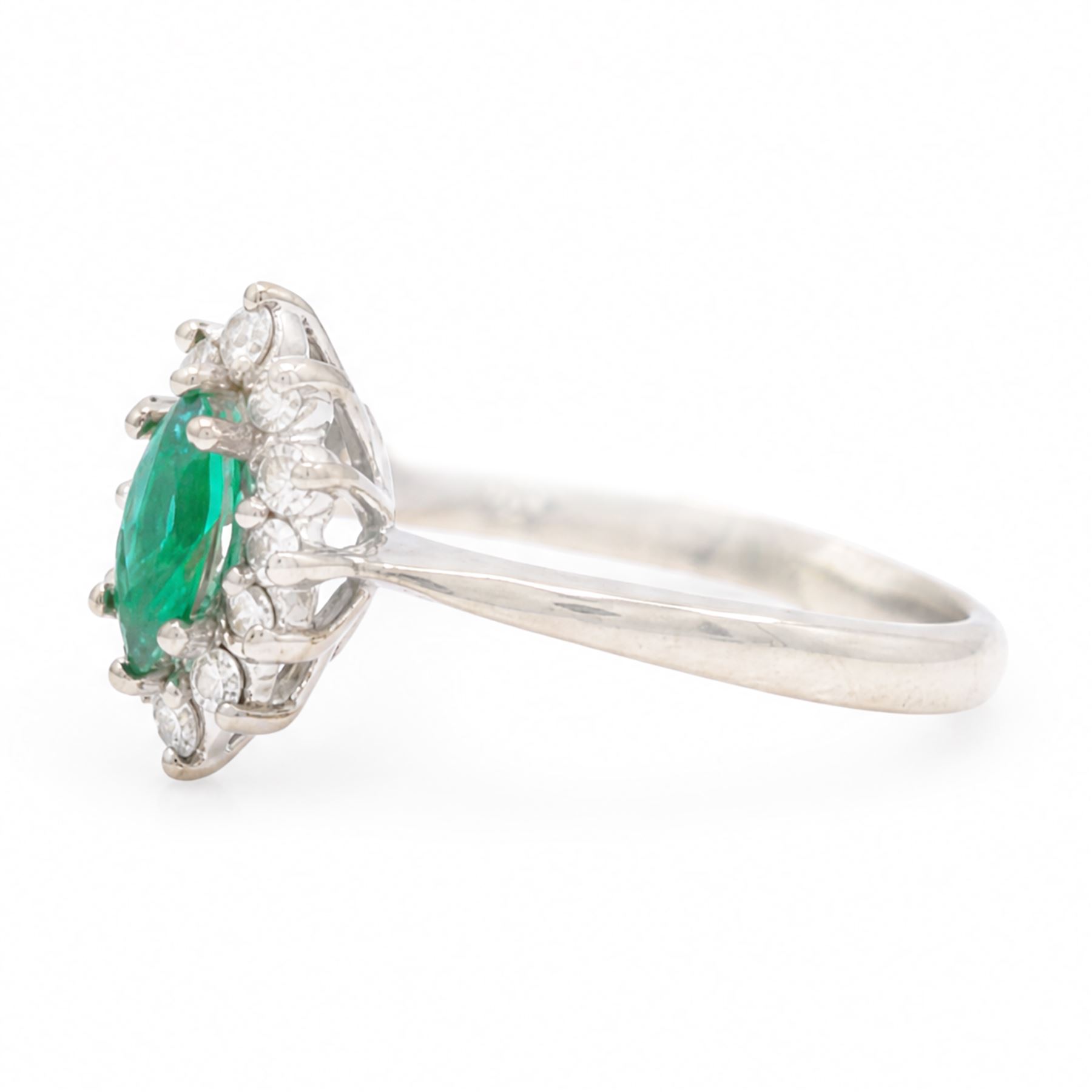 18ct white gold emerald and diamond cluster ring, single marquise cut emerald 0.25 carat, surrounded by twelve round brilliant cut diamonds, London 1979, total diamond weight approx 0.25 carat