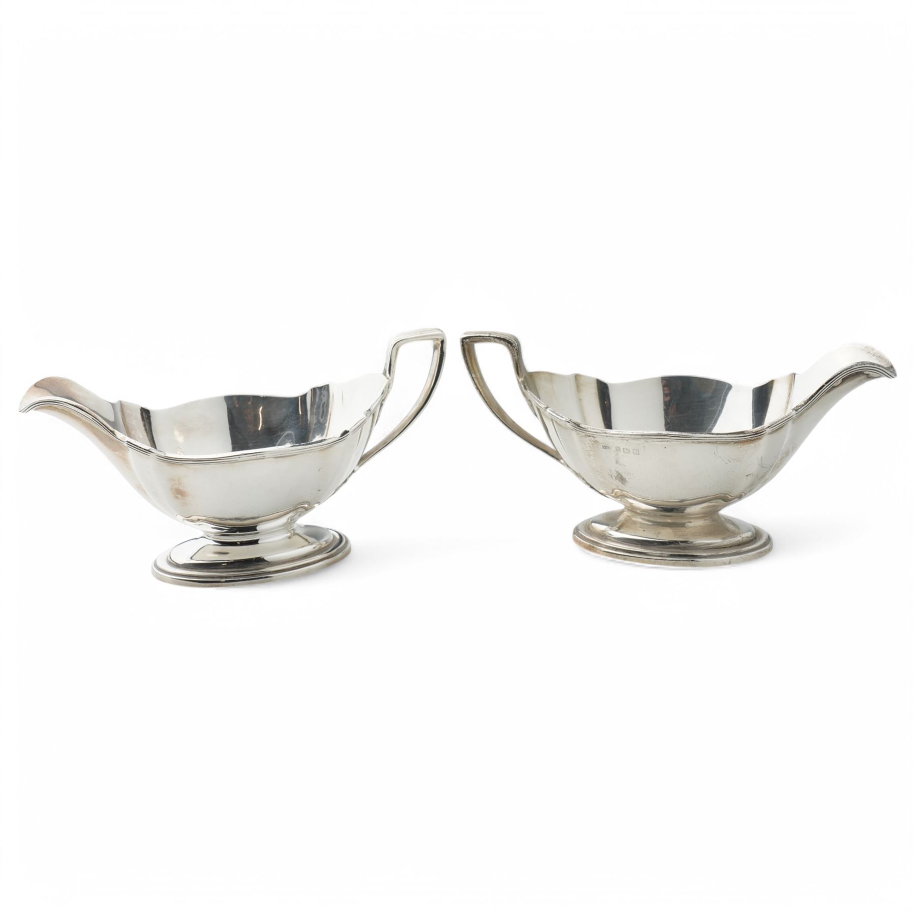 Pair of silver sauce boats with crimped reeded rims, angular handle and on pedestal foot Birmingham 1916 Maker Gorham Manufacturing Co.