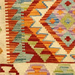 Two Chobi Kilim flatweave rugs, comprising the largest kilim on a cream ground with a grid of stepped diamond medallions in a palette of rust red, turquoise, green, ochre, and lilac,, filled lozenge motifs, framed by a cream ground border, 148x101cm, Chobi Kilim with multi-stepped diamond medallion with serrated bands, in terracotta, turquoise, green, saffron and blue, framed by a broad polychromed border of stylized guls and narrow guard stripes, 114x87cm 
