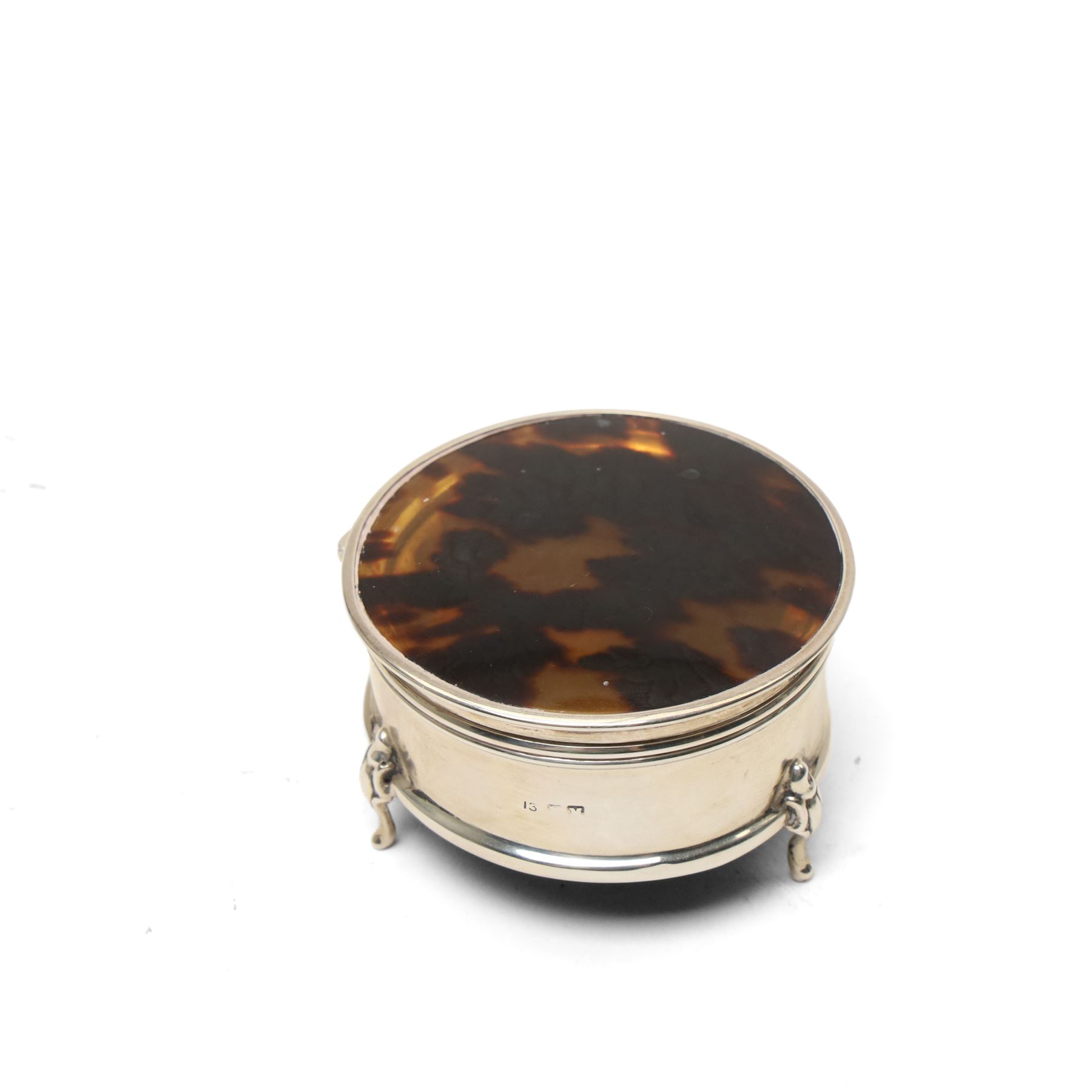 Silver circular ring box with hinged tortoiseshell cover, glass block inkwell with pique tortoiseshell cover Birmingham 1921 and a silver napkin ring (3)