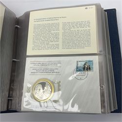 Thirty-one 'International Society of Postmasters Official Commemorative Issues' sterling silver proof medallic covers dating from 1975 to1977, housed in the official folder and a 'Commemorating The Bicentennial Of The United States Of America' sterling silver proof medallic first day cover in blue wallet