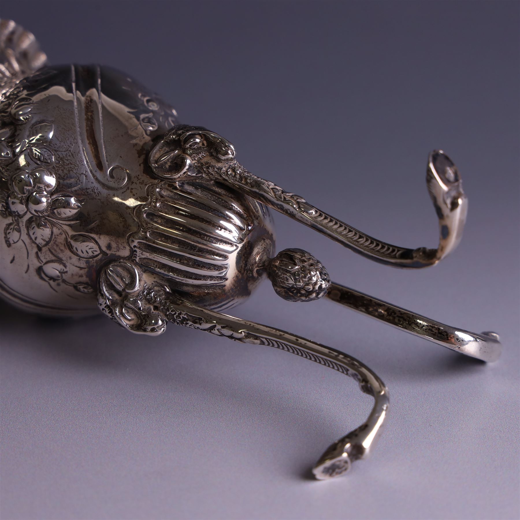 Late Victorian silver vase, of baluster form with fluted rim, the body with embossed floral decoration, upon three tall legs with ramshead mounts, hallmarked William Comyns & Sons, London 1890, H13.5cm