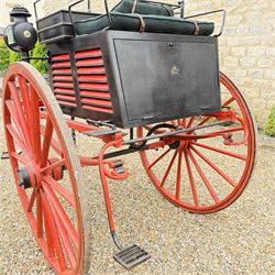 Holland & Holland Tandem Cart - Althorp Spencer Family Estate

A two wheeled tandem cart or cocking cart by Holland & Holland Coach Builders, London, with black painted bodywork, red painted shafts and running gear, red wooden spoked wheels with rubber tyres, green upholstered seating and a rear perforated metal footboard. The cart is fitted with carriage lamp brackets (lamps next lot), green buttoned cushions with leather retaining straps, side louvered body panels, footrests, leaf spring suspension and shafts for horse use. The carriage incorporates an adjustable body position, operated by a lever, allowing the body to be moved forwards or backwards to alter the weight distribution. Formerly owned by the family of Lady Diana Spencer,
Sympathetically conserved by Woods of Fairbourne Carriages Ltd, Kent.

Features:
• Brass maker’s plaque for Holland & Holland Coach Builders, London
• Two wheeled tandem cart
• Black painted body with red painted shafts and running gear
• Red wooden spoked wheels with rubber tyres
• Green upholstered cushions with leather retaining straps
• Adjustable carriage body for weight distribution
• Lever operated adjustment mechanism
• Perforated rear footboard
• Side footrests
• Louvered side panels
• Leaf spring suspension
• Rear opening storage compartment
• Decorative painted armorial motif to rear panel
• Fitted carriage lamps shown, not included in the lot (available as next lot)
• Conserved by Fairbourne Carriages Ltd
• Provenance: The Althorp Attic Sale including The Spencer Carriages, lot 195, 7 July 2010

Dimensions:
Overall length 396 / 198cm
Width 155cm
Height 190cm

Wheel Diameters:
Wheels: 148cm

Seating:
Driving seats: 2
Passenger seats: 2